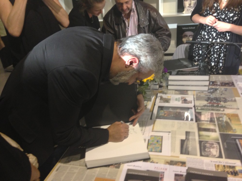 Artist Safwan Dahoul signing his book. Courtesy: Al Mahha Art Blog