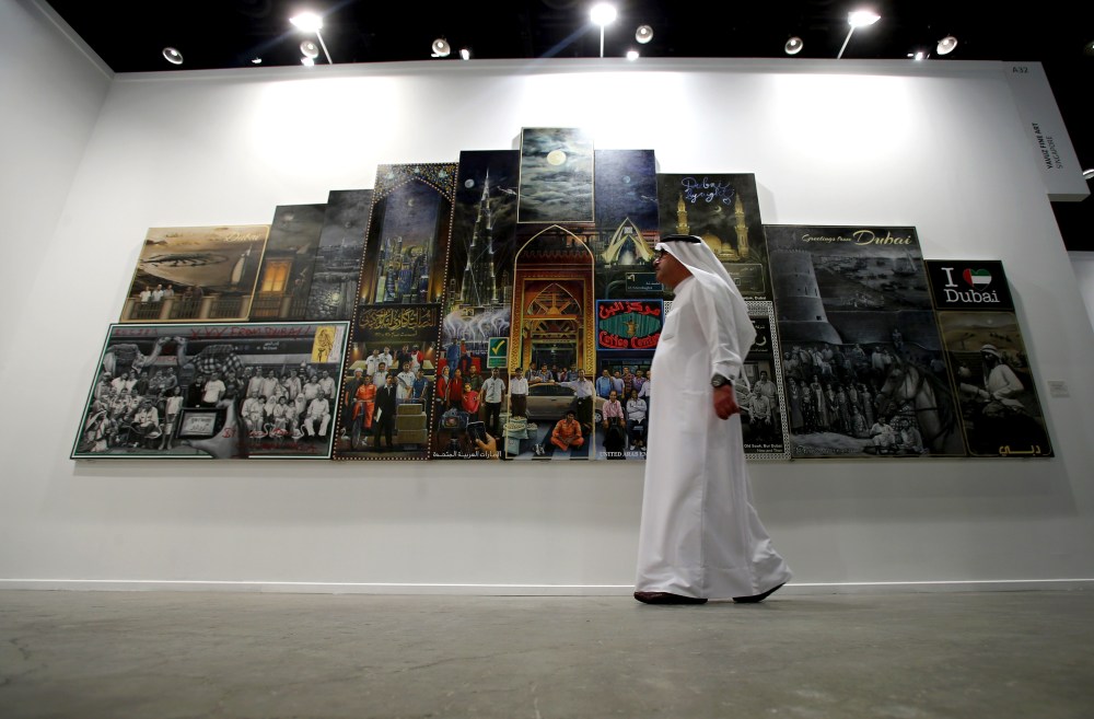 A visitor walks past the work of Thai artist Navin Rawanchaikul during  Art Dubai 2014. Courtesy: Getty Images for Art Dubai.